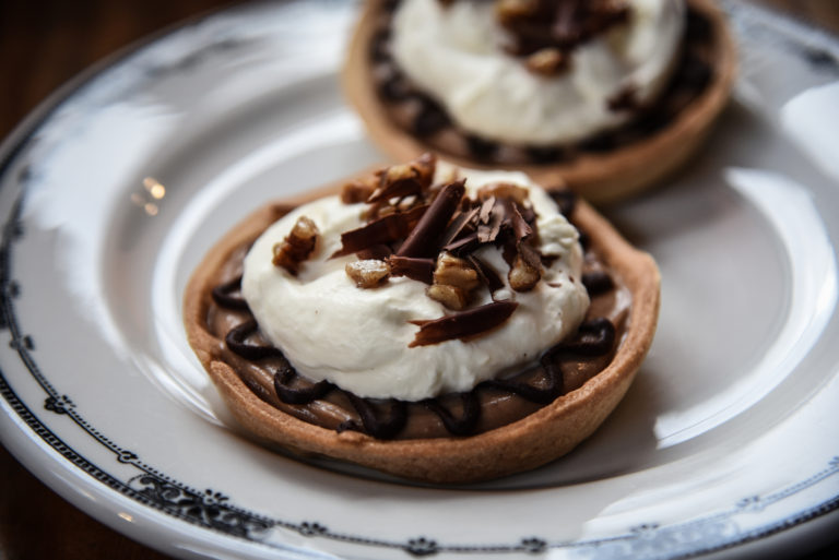 A close up of two small pies on a plate