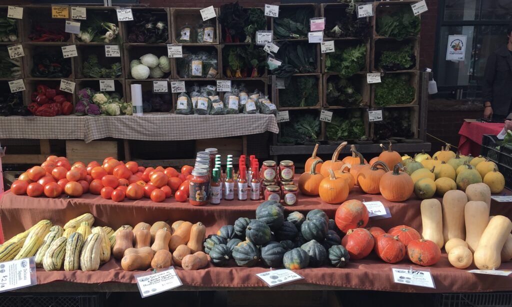 fresh vegetables like pumpkin, tomato, and more in a market