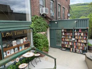 Outdoor bookshelves and cafe table at bookstore on Main Street